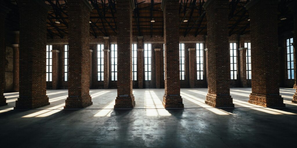 Loft-style interior with brick columns and tall windows